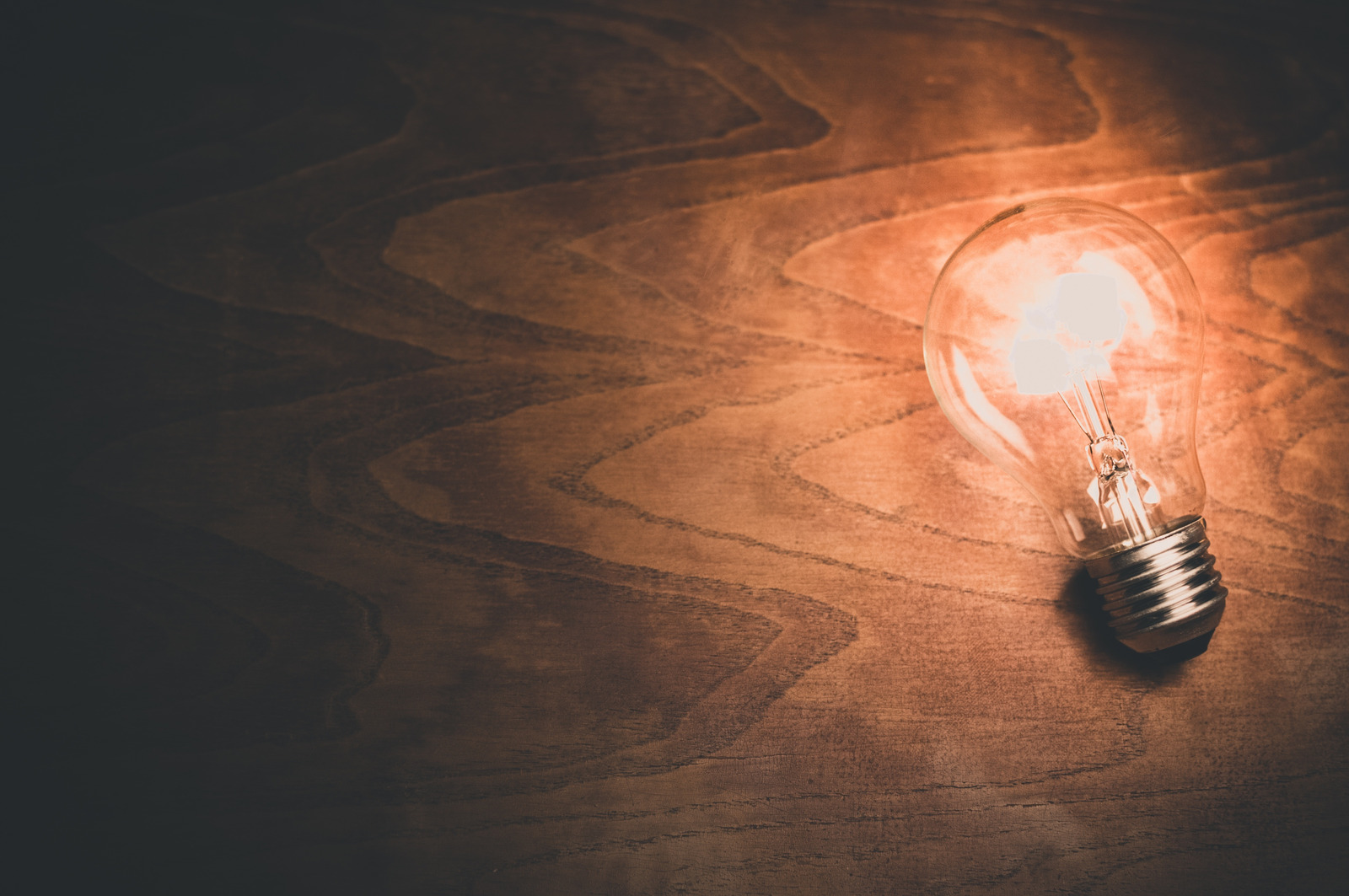 Canva - Light Bulb on Wooden Background